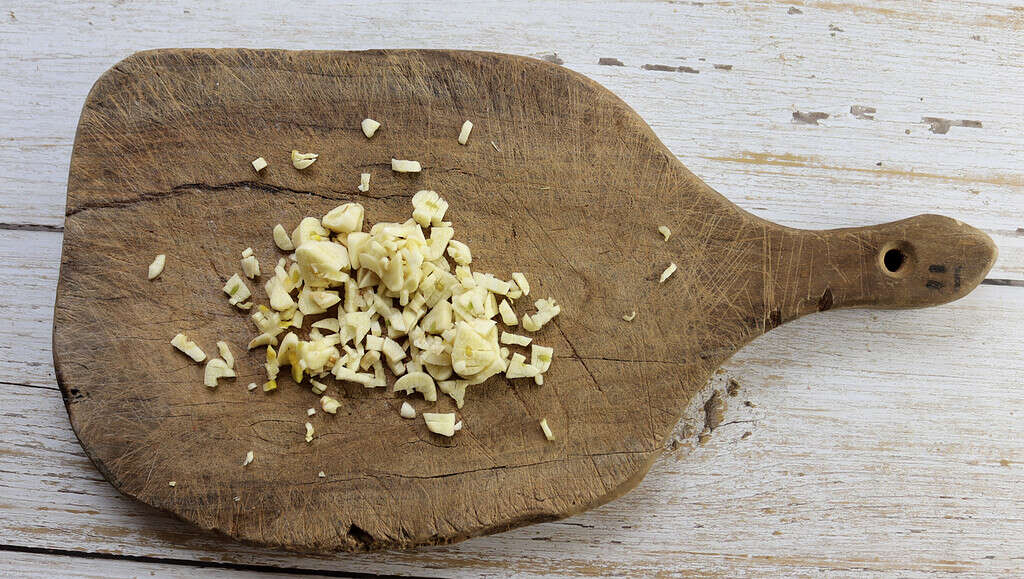 image showing chopped garlic before frying it with the onions