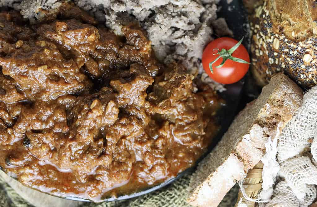 Authentic gulasz wolowi (polish beef goulash) served on a plate with buchwheat dumplings