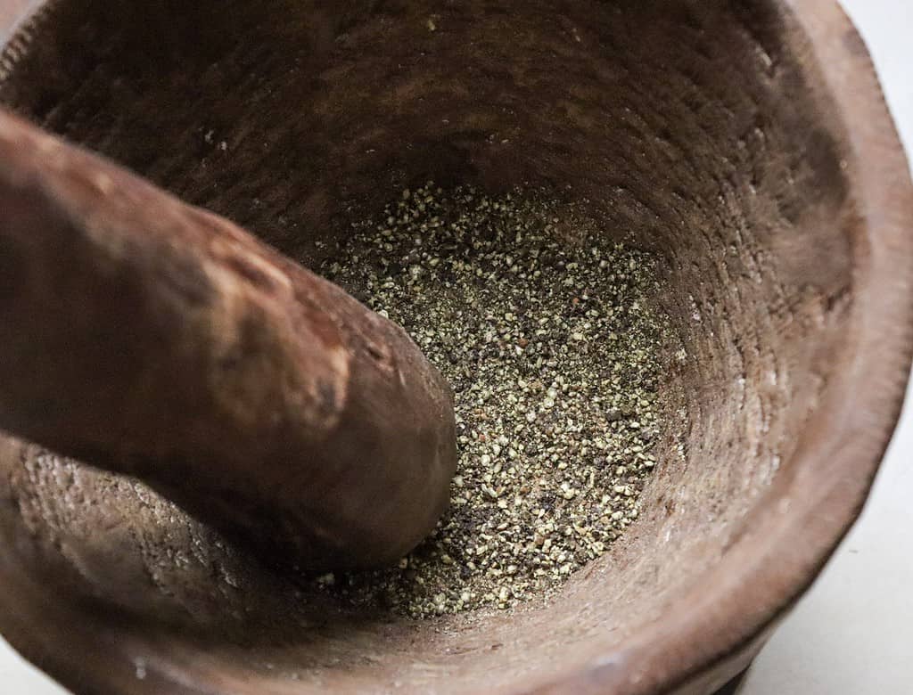 cracking black pepper for focaccia