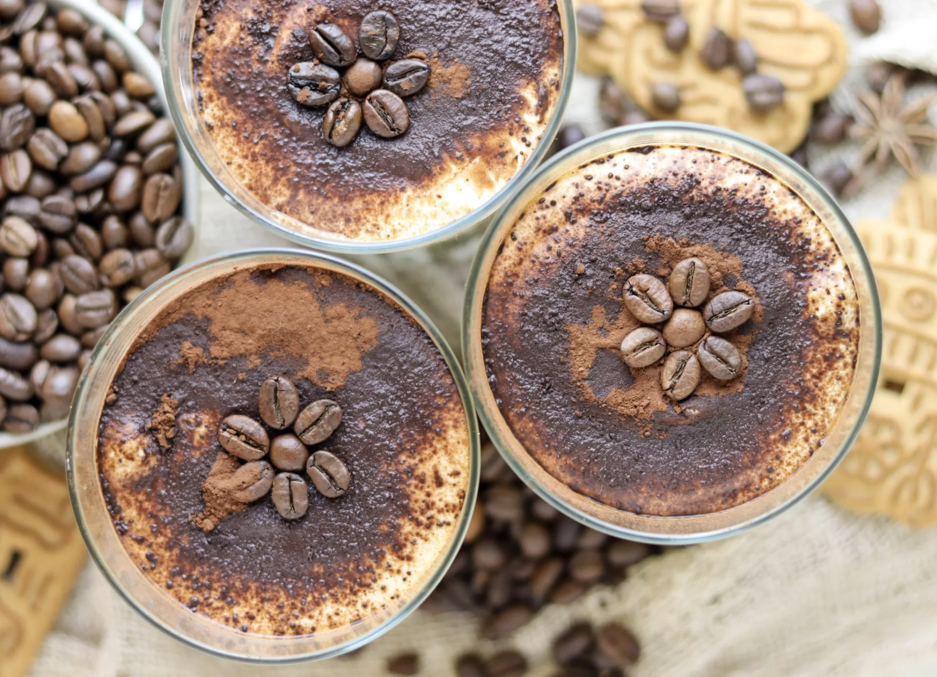 Three speculoos tiramisu cups with cookies and coffee