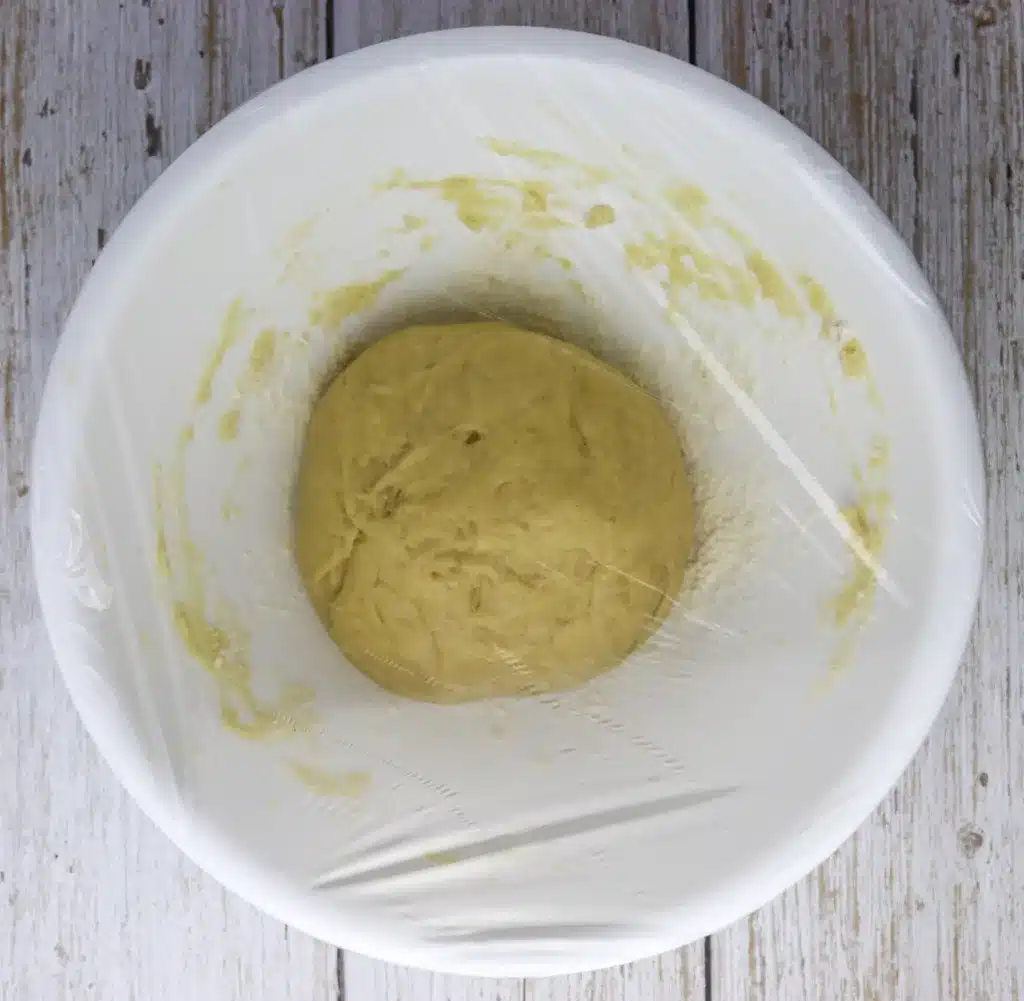 step: image showing how to cover the dough with plastic foil and let it rest in the refrigerator