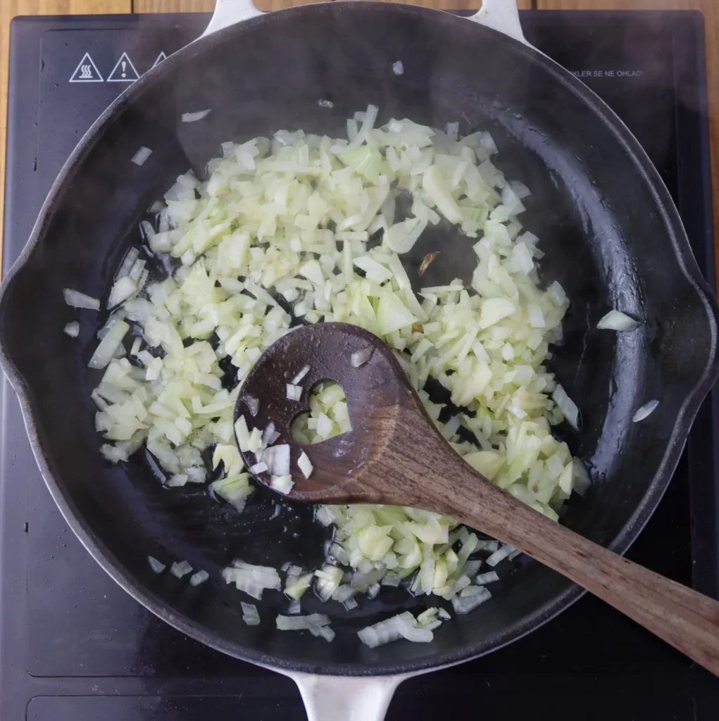 step five: stir-frying the onions and garlic in hot olive oil or lard for ricet soup