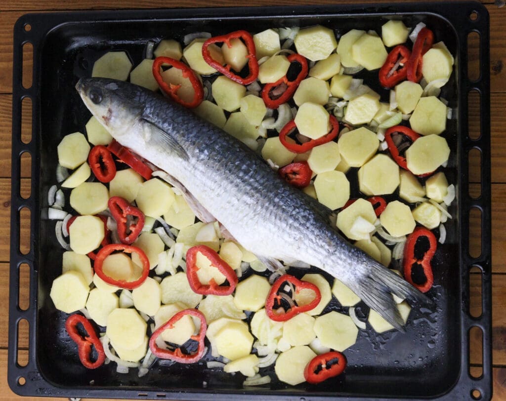 image showing how to add vegetables to a baking tray and season them with salt