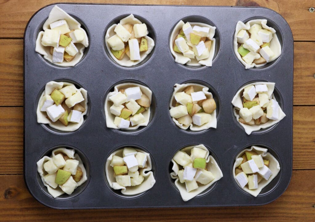 image showing how to fill the bites with pieces of brie cheese and pears 