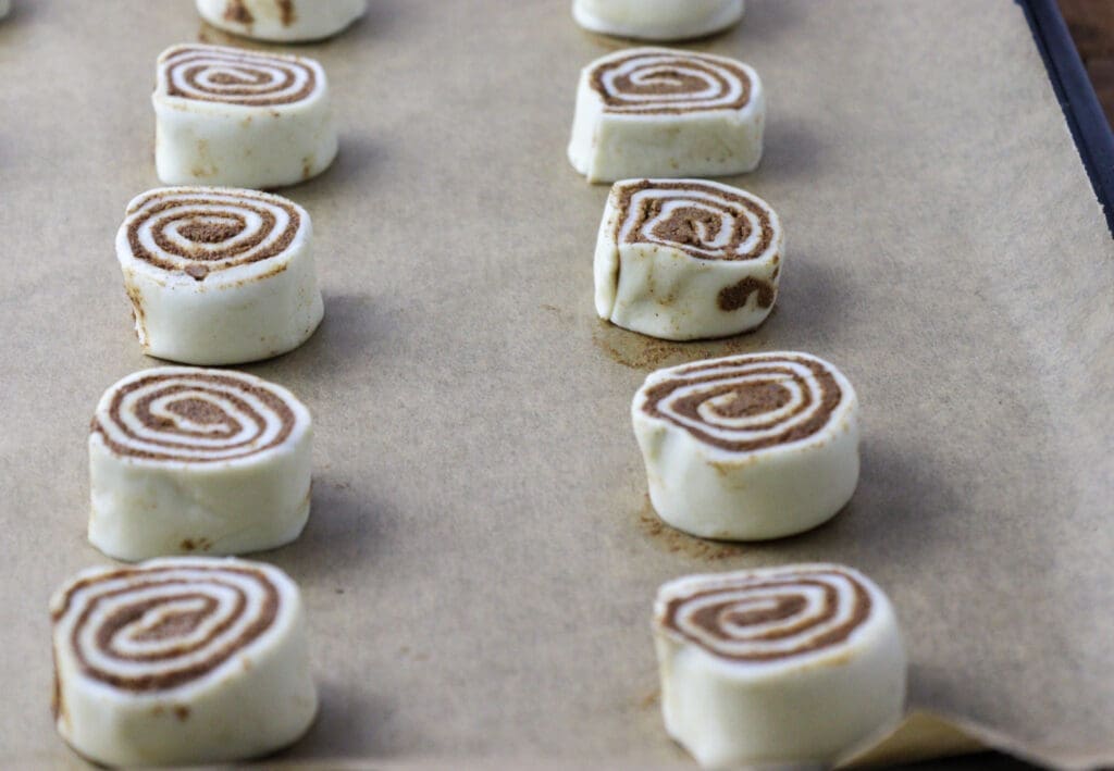 image showing puff pastry pinwheels placed on a baking sheet