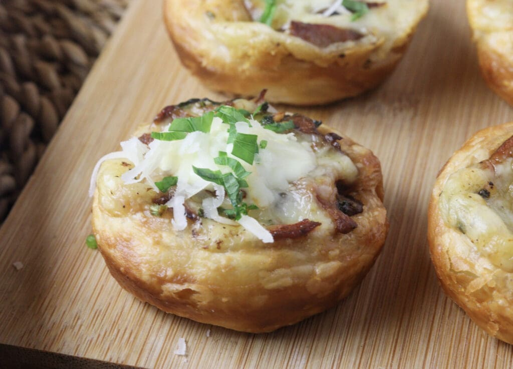 Lactarius deliciosus tartlets sprinkled with grana padano and fresh parsley