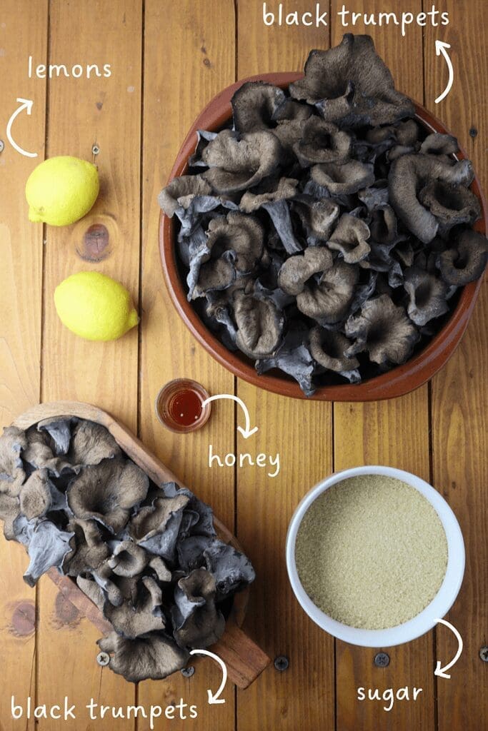 gathering ingredients for mushroom jar: black trumpet mushrooms, brown sugar, forest honey and lemons