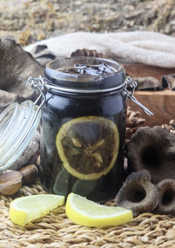 image of black trumpet mushroom jam canned in a jar with lemon slices 