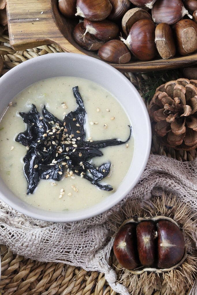 image showing how to add black trumpet mushroom to the soup, sprinkled with sesame seeds