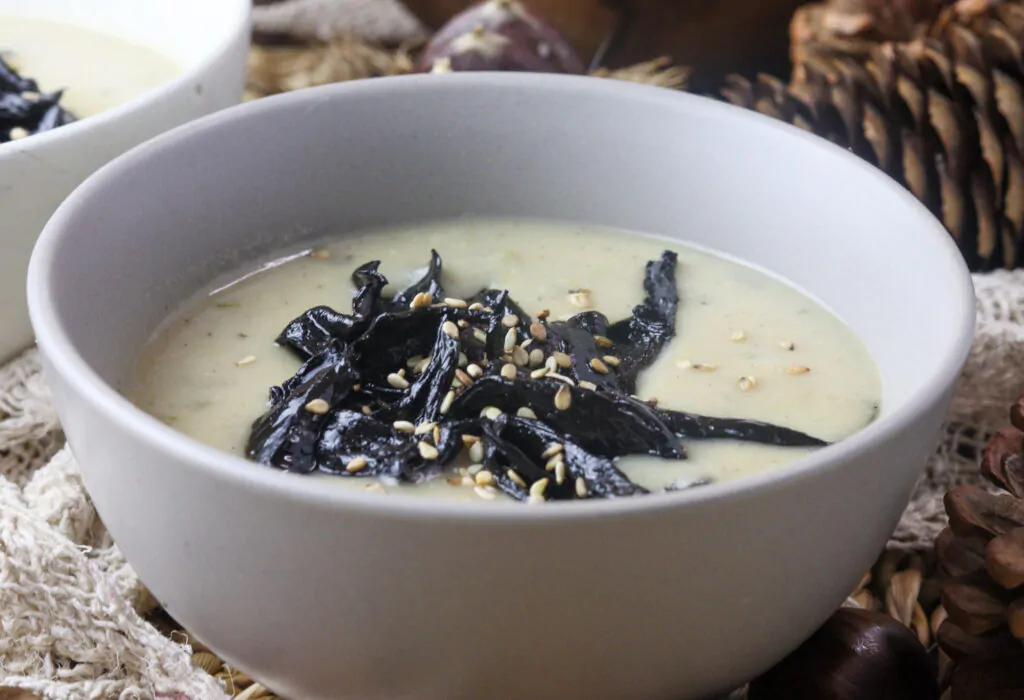 delicous pear potato soup with black trumpet mushrooms served in a bowl 