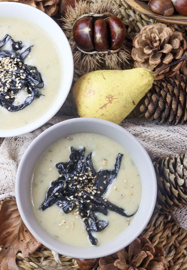 pear potato soup with mushrooms on the table with pears and chestnuts in the background 