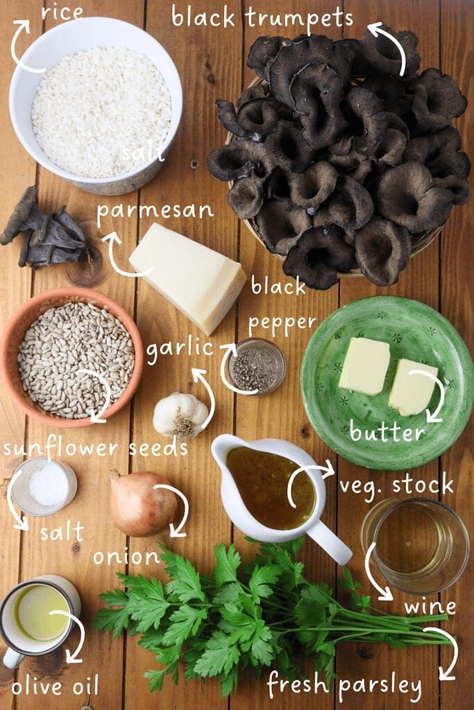 gathering ingredients for black trumpet risotto: black trumpet mushrooms, Aborio rice, butter, wine, parmesan cheese, vegetable stock, sunflower seeds, fresh parsley, salt and black pepper