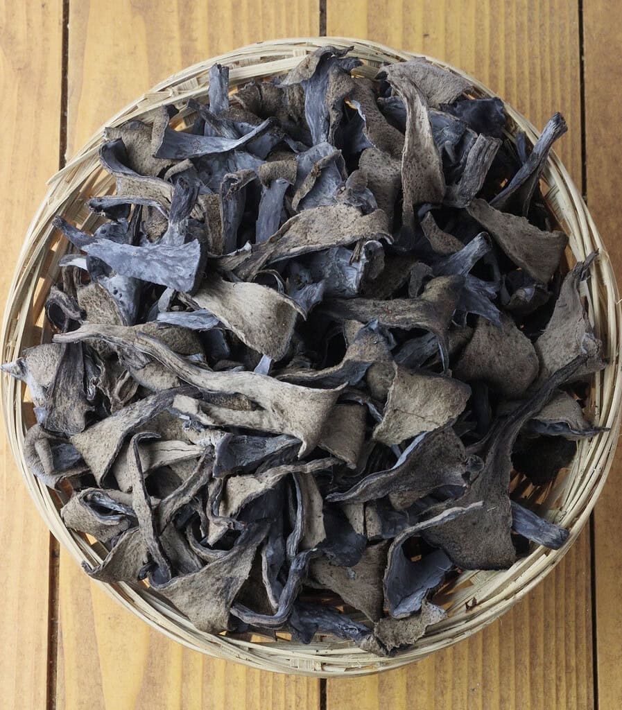 image showing how to clean black trumpet mushrooms and split them into smaller chunks