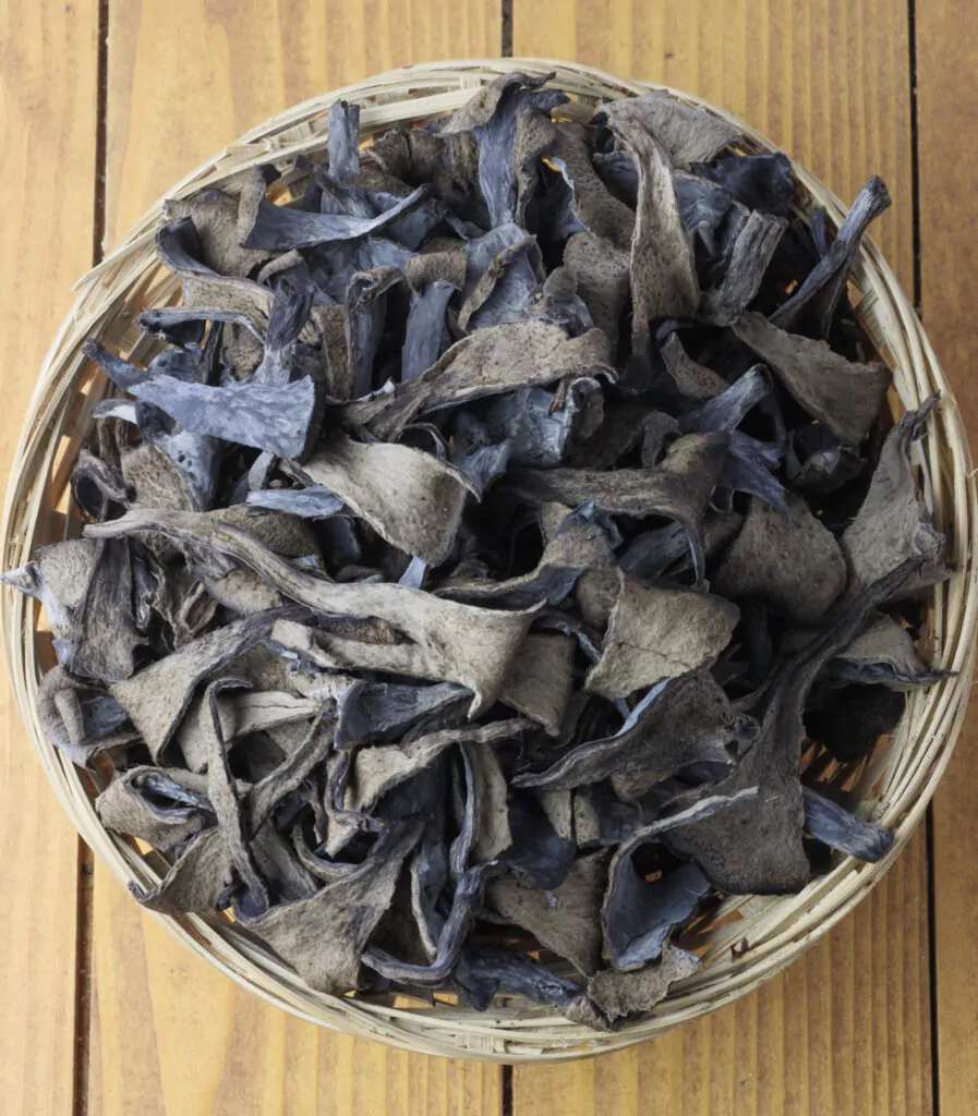 image showing how to clean black trumpet mushrooms and split them into smaller chunks