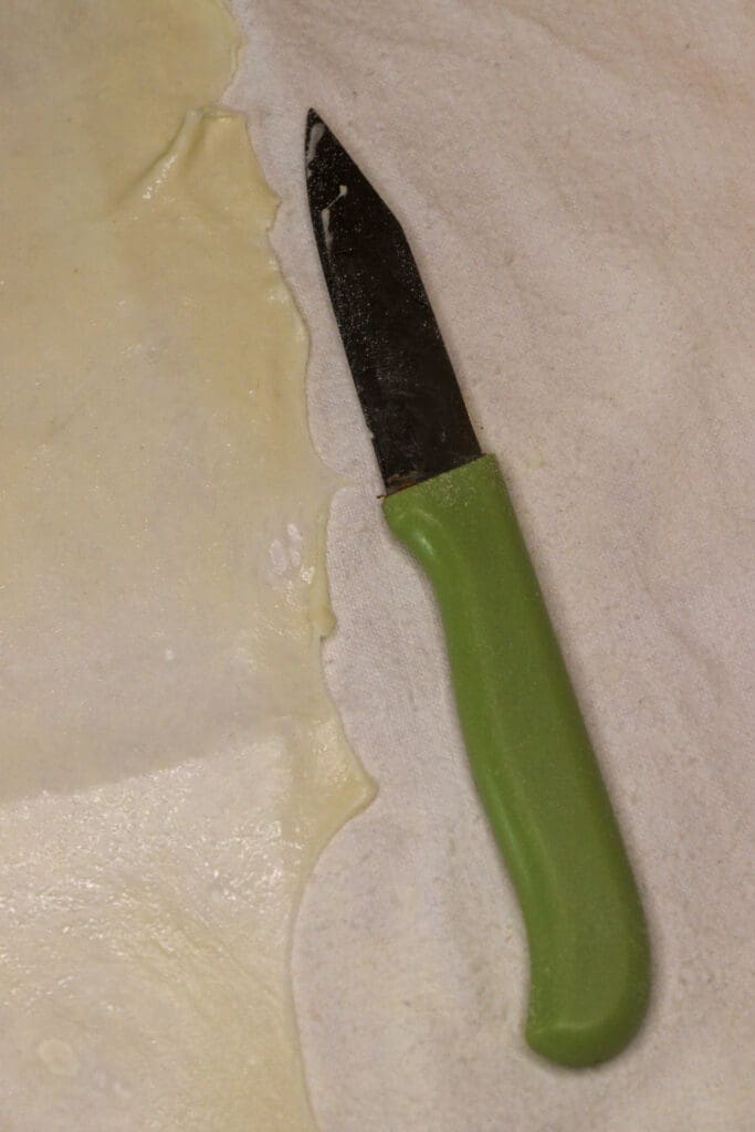 image showing how to cut the edges of the dough using a small knife