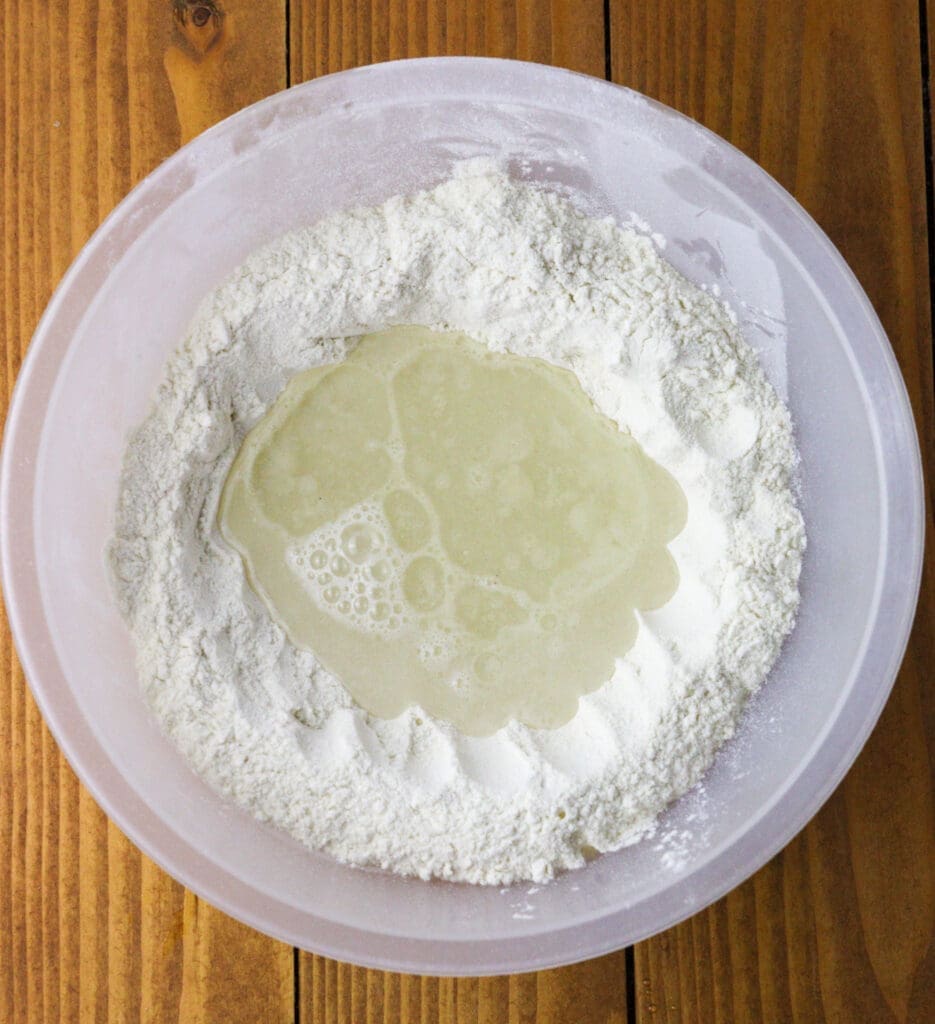 image showing how to mix the flour, salt and water in a bowl when making the dough for strudel