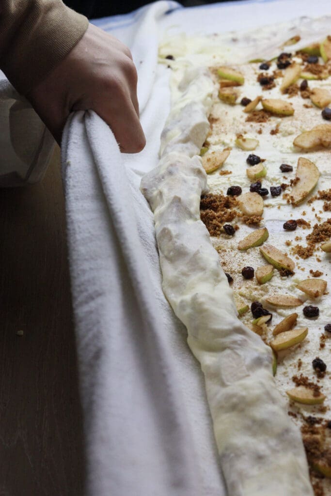 image showing how to roll together the cheese strudel filling with a kitchen towel