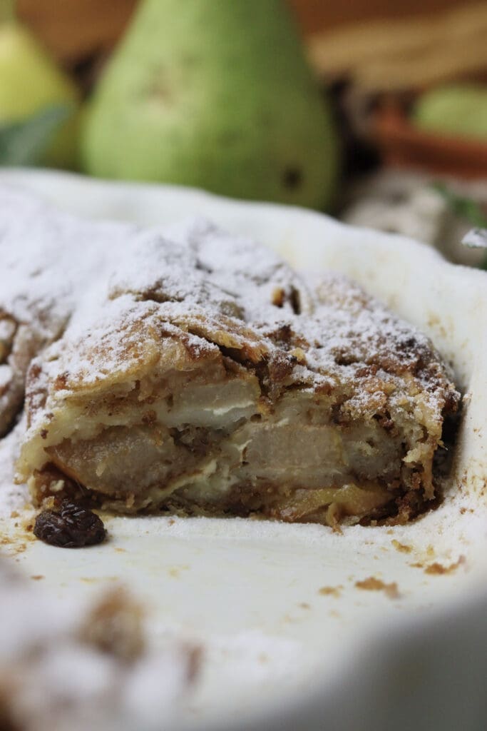 image of a sliced pear cheese strudel in ta pan