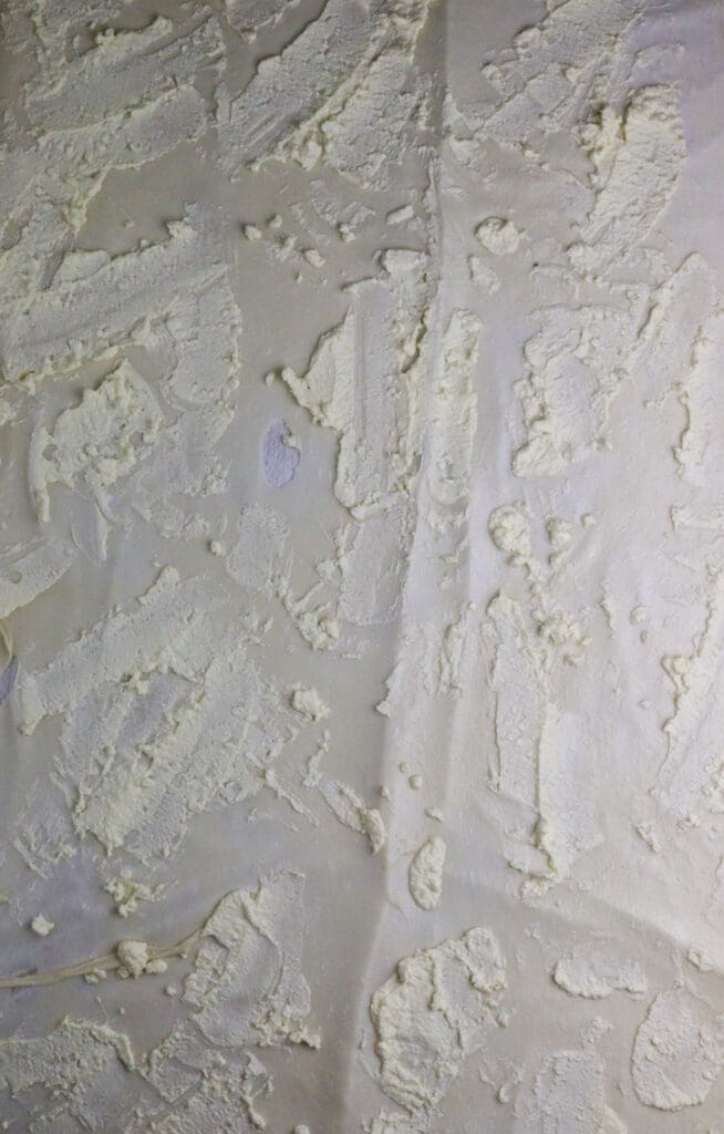 image showing how to add cottage cheese and egg mixture to the dough