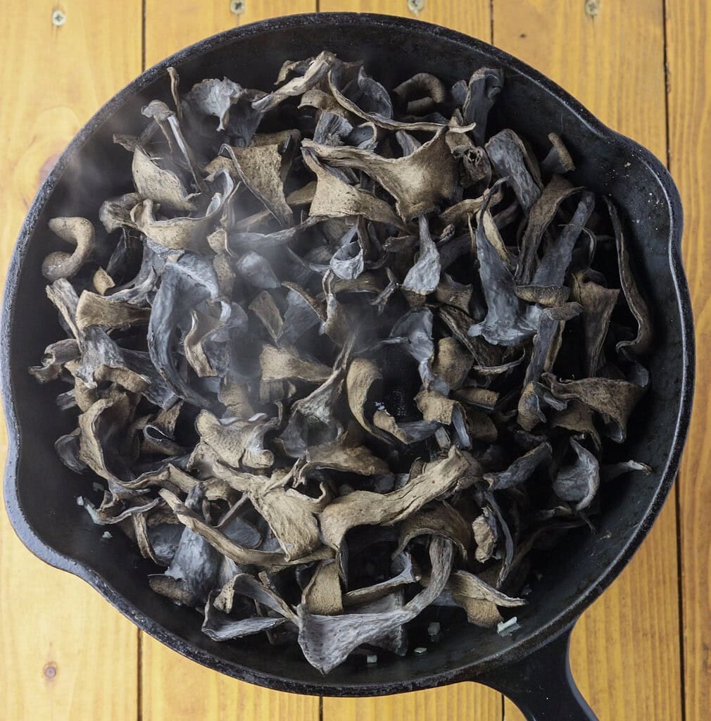 image showing how to add black trumpets to the pan