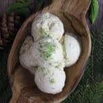image of mouth watering no churn spruce tip ice cream with spruce tips and spruce branches in the background