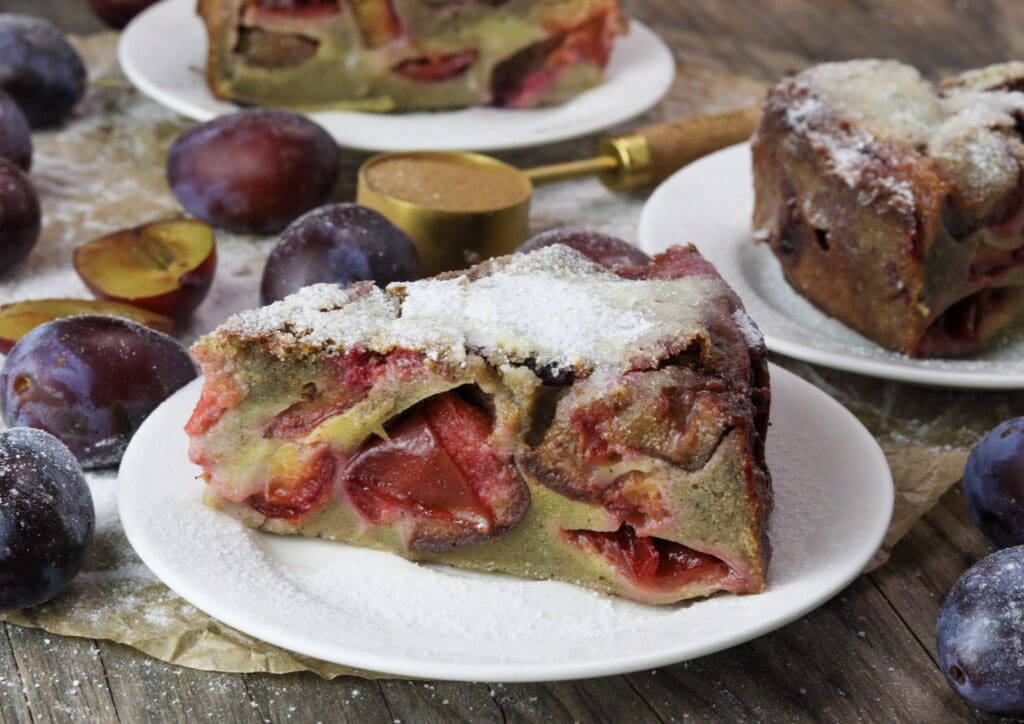 Delicious buckwheat plum clafoutis slices served on the table - a perfect gluten-free plum dessert. 