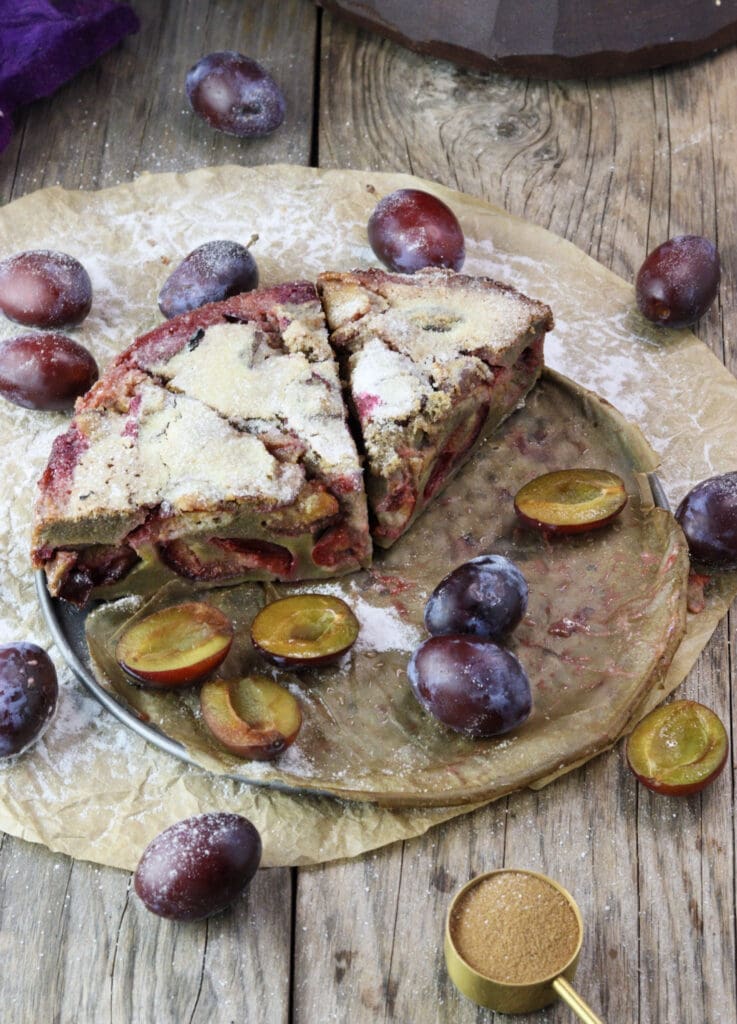 Freshly baked buckwheat plum clafoutis recipe,  sliced and ready to enjoy.