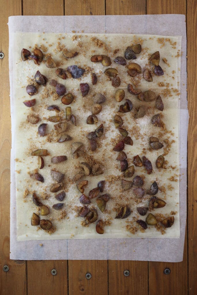 Plums sprinkled with cinnamon before baking.