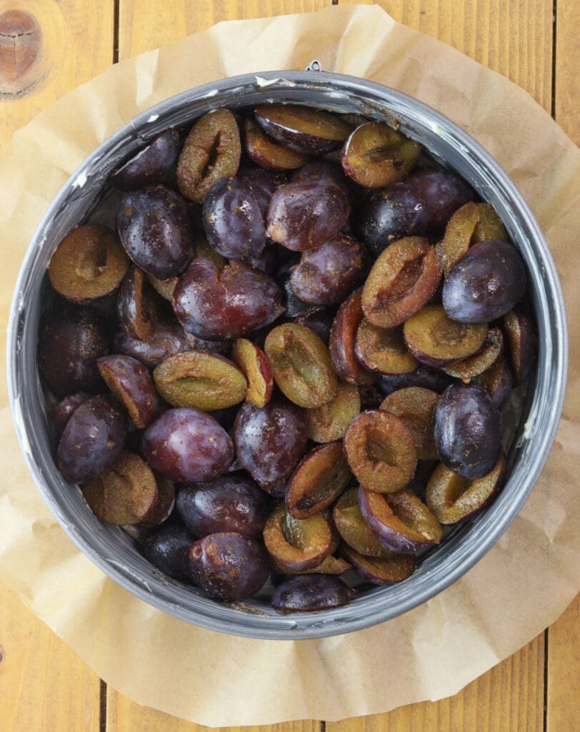 Placing the plums at the bottom of the baking pan 