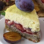 A slice of plum cheesecake with a plum