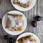Three plates of delicious plum strudel with cinnamon.