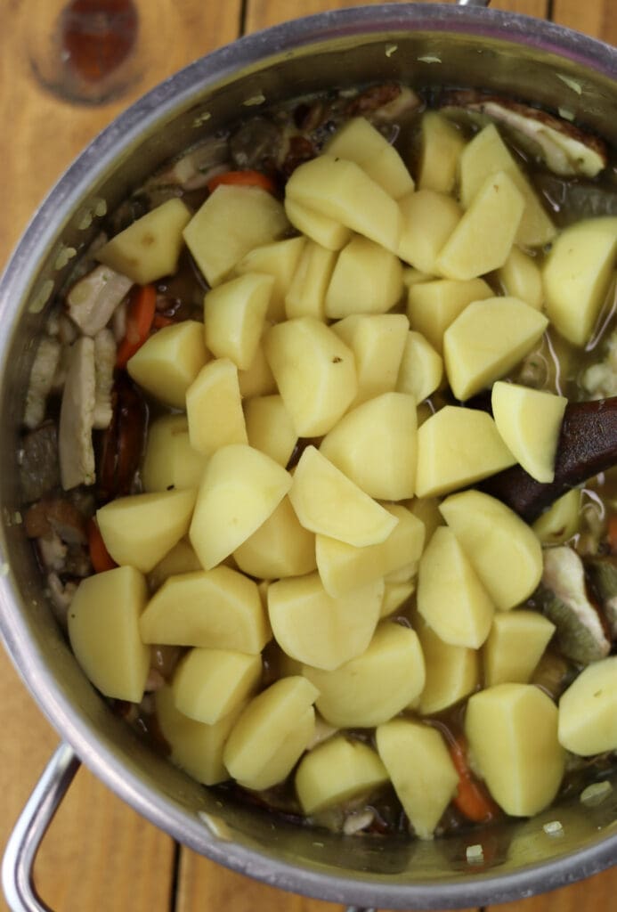 Image showing how to add diced potatoes to the soup