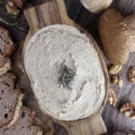 Delicious, creamy porcini mushroom walnut pate with walnuts, porcini mushrooms, rosemary and fresh bread in the background