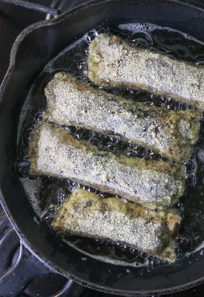 Frying the rolls in a cast iron skillet on medium heat.