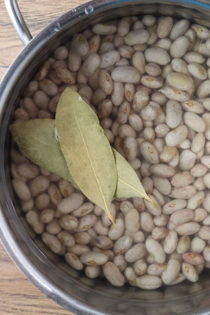 How to cook the beans before adding them to the soup together with two bay leaves