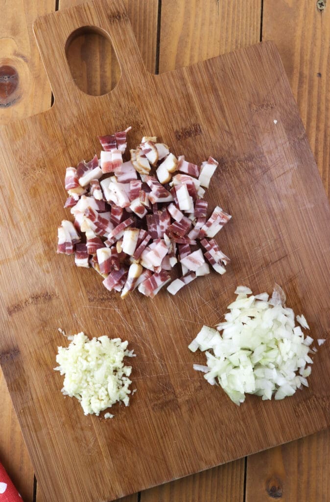 How to slice the smoked bacon into small chunks, dice the onion and crush the garlic for the soup