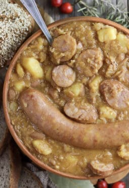 Freshly cooked jota soup with homemade bread in the background.