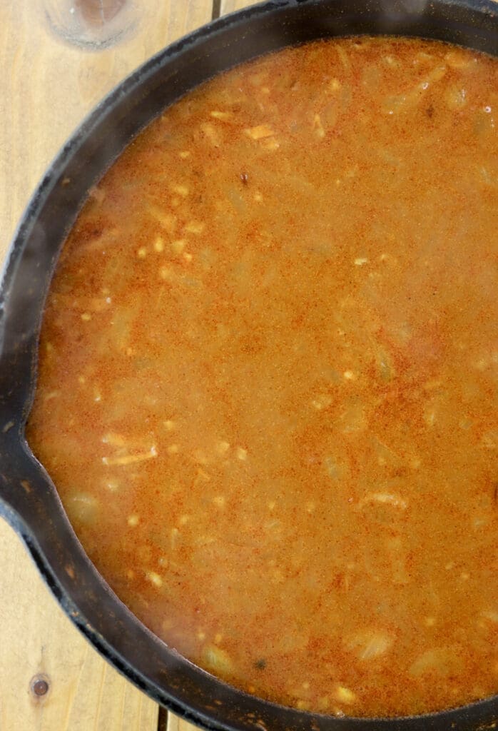 Adding water to the sauce and cooking it for a few minutes before adding the sauce to stuffed cabbage rolls.