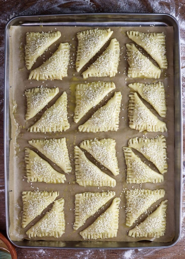 Crackling cookies before baking covered with egg wash and sprinkled with sesame seeds.