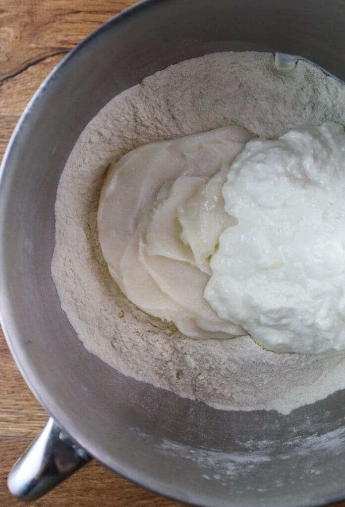 Mixing flour, lard, baking powder and sour cream for the cookie dough