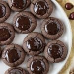 A full plate of buckwheat thumbprint cookies with chocolate filling with added orange zest.