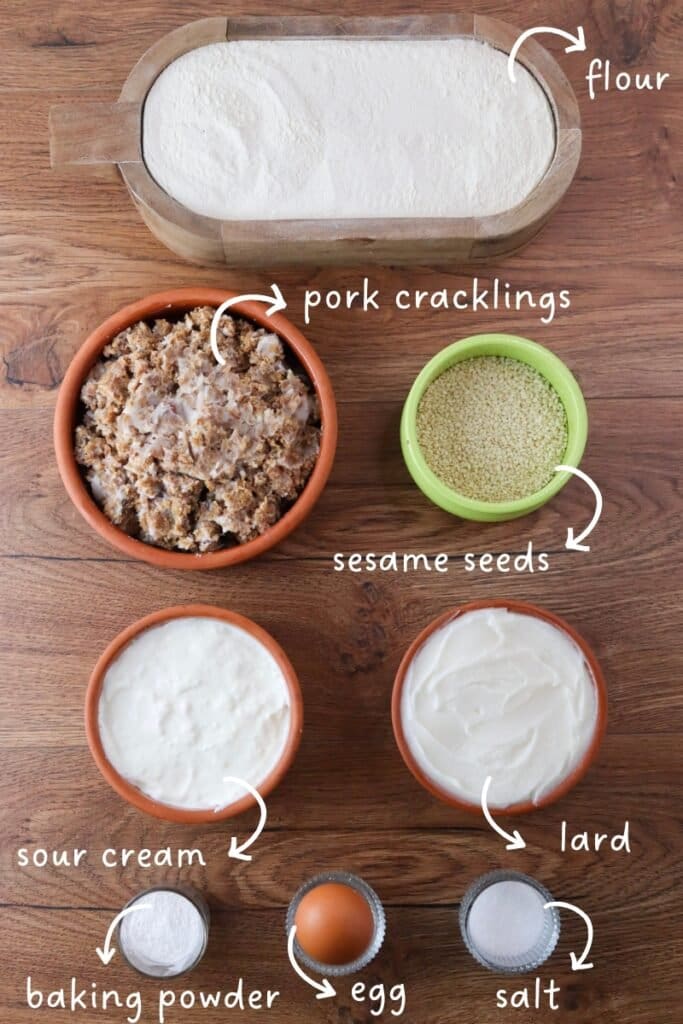 Gathering ingredients for crackling cookies; pork cracklings, flour, lard, an egg, sour cream, baking powder, salt