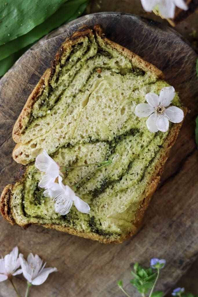 A slice of wild garlic bread with white cherry flowers.