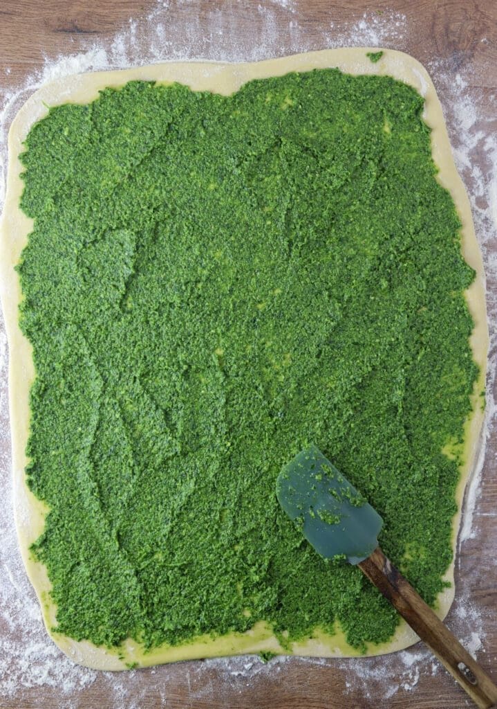 How to spread the wild garlic pesto on the dough before rolling it into a babka loaf.
